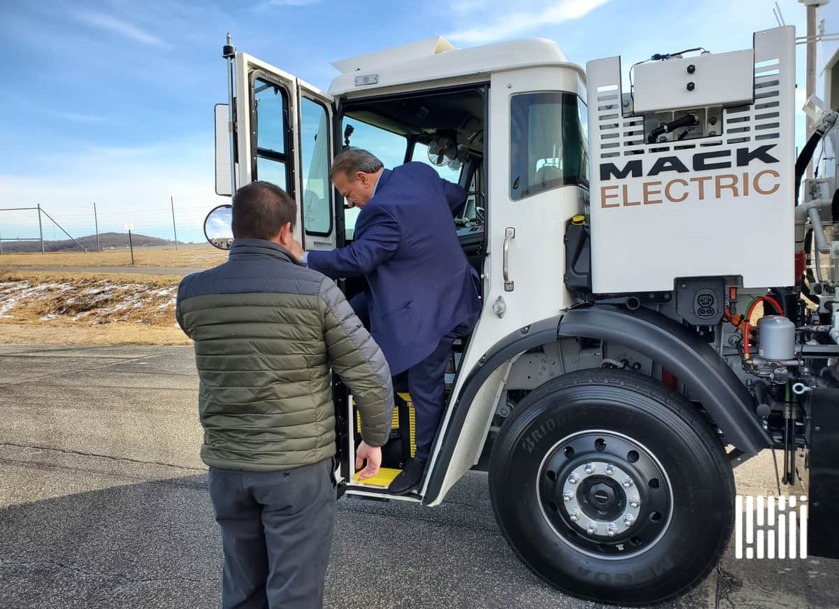 NYC Sanitation Deputy Commissioner Rocky DiRico steps out of Mack LR Electric refuse truck