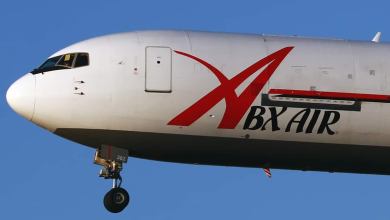 Close up of white cargo jet, front end, in flight