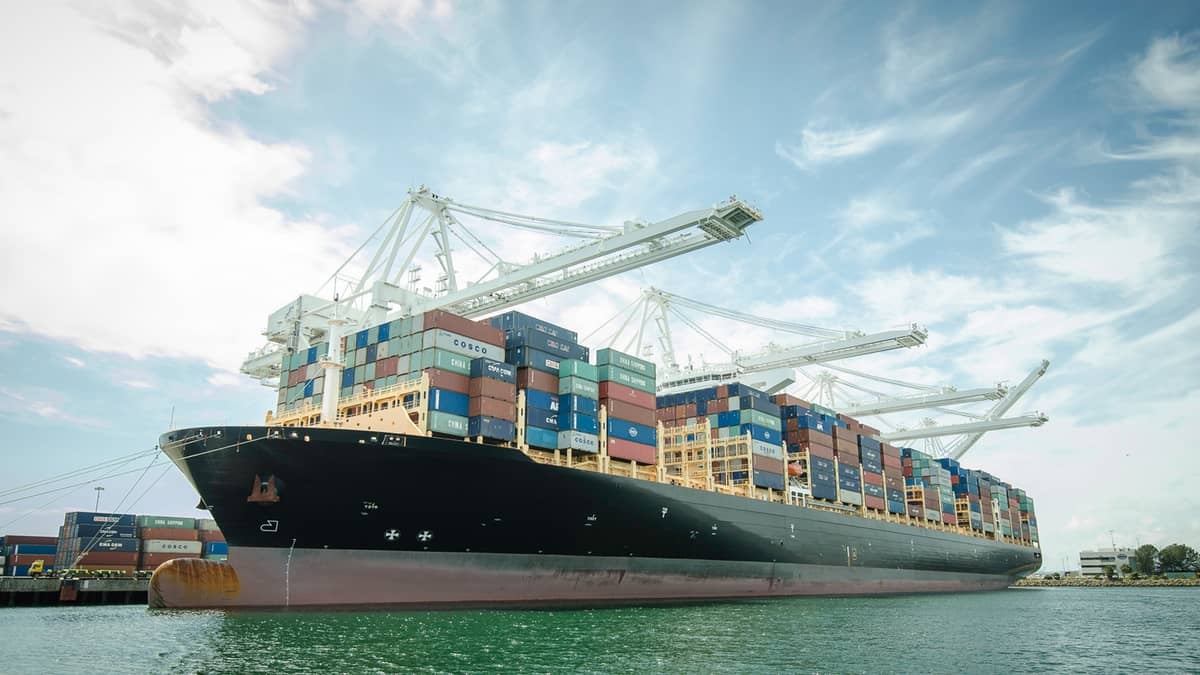 Container ship at port stacked with containers.