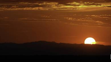 Sun just above the horizon of the Southwest desert sky.