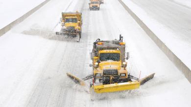 Plows clearing a snowy Pennsylvania highway.