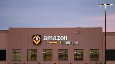 A brown Amazon warehouse with sign on front.