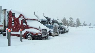 Tractor-trailers parked during a California snowstorm.