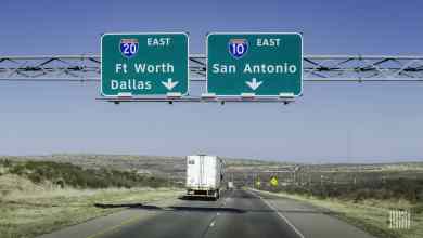 Tractor-trailer heading down I-20 in Texas on a sunny day.