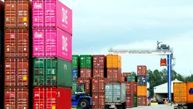 A photograph of containers stacked at a yard.