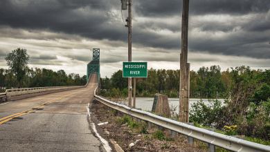 A photograph of a rural highway crossing the Mississippi River.