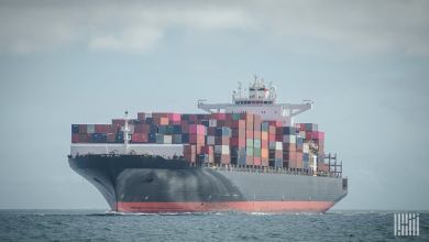 A container ship travels on the water to illustrate an article about cybercriminals selling access to shipping firms