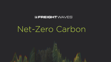 The logo for FreightWaves' Net-Zero Carbon show has green trees with a black background.