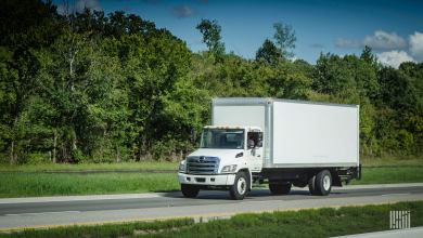 White box truck driving down the highway