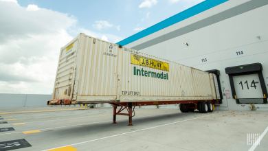 A J.B. Hunt intermodal trailer backed up to a warehouse door