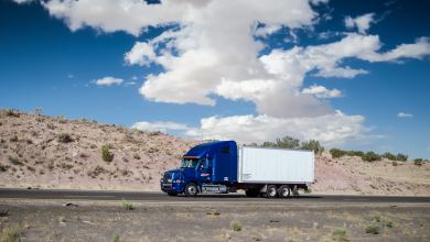 box truck driving past mountains