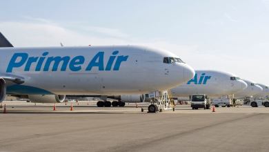 Prime Air freighters with light blue lettering lined up on the tarmac side by side.