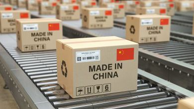 Made in China printed on boxes that are moving on a conveyor belt.