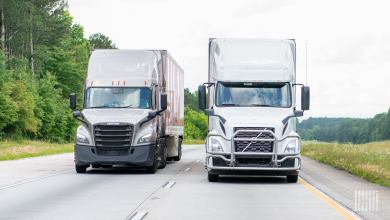 Front view of two tractor-trailers on a highway