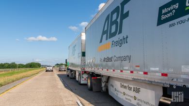 Two ABF LTL trailers being pulled on a highway