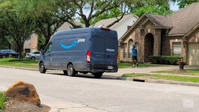 An Amazon delivery van makes a stop in a residential neighborhood.