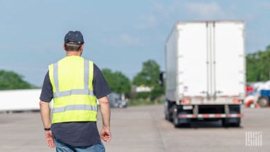 Man watching truck with driver in skills test