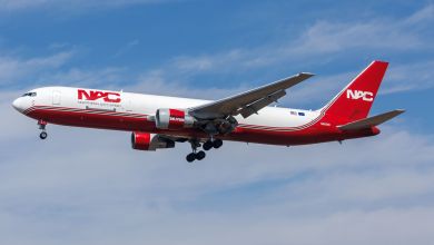 Red-and-white Northern Air Cargo Boeing 767 aircraft approaches airport for landing.