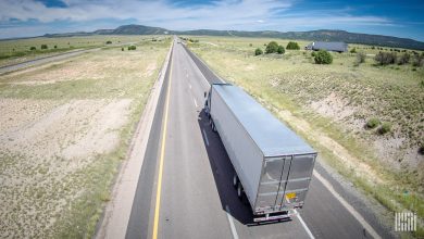 Tractor trailer driving down a highway