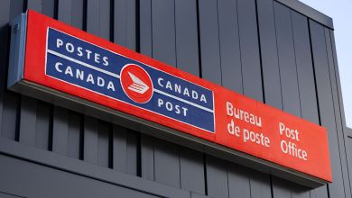 Red-and-blue sign for Canada Post office.