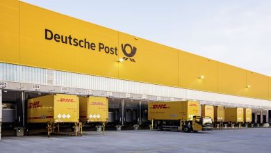 A bright yellow cargo terminal with Deutsche Post logo on the side.