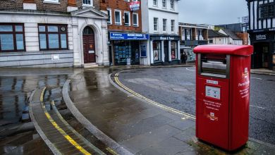 A red roadside parcel post box in the UK.