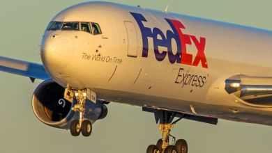 A front close-up a large FedEx freighter aircraft as it flies low for a landing.