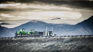 truck hauling farm equipment