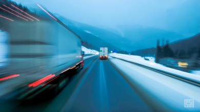 Trucks driving in snow in evening