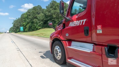 a closeup of a red Averitt tractor on a highway