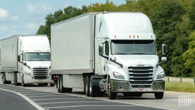 white tractor-trailers on a highway
