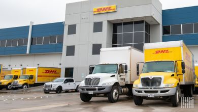 DHL box trucks seen parked at a DHL warehouse.