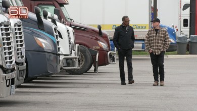 60 Minutes correspondent Bill Whitaker interviews Rob Carpenter, FreightWaves contributor and trucking safety consultant, in front of semi-trucks during the chameleon carriers investigation