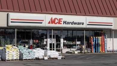 Front of an Ace Hardware store with products displayed on the sidewalk.
