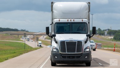 front view of a white tractor on a highway