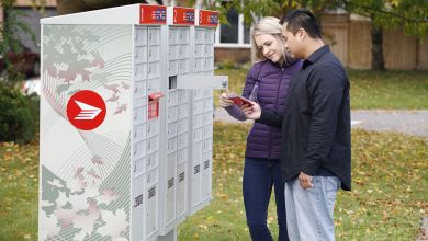 A man and a woman check a letter they removed from a Canada Post community mailbox.