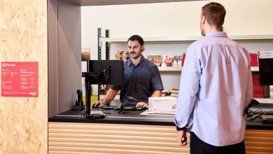 A customer drops off a package at Australia Post.