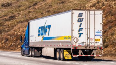 A Swift trailer being pulled on a highway