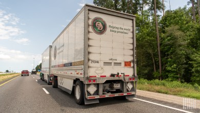 a rearview of two Old Dominion pup trailers being pulled on a highway