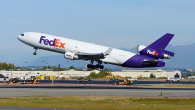 A purple-tailed FedEx jet takes off.