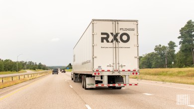 An RXO dry van trailer being pulled on a highway