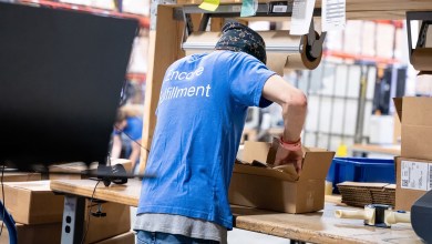 A worker fills e-commerce orders in a warehouse.
