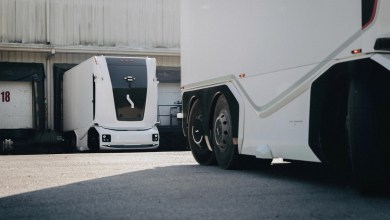 White Einride cabless autonomous electric truck parked outside a warehouse