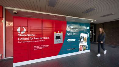 A view of a red Australia Post parcel locker with a an advertisement for Vinted e-commerce company.