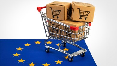 A shopping cart with parcels sits on top of the EU flag to represent e-commerce in the regional block.
