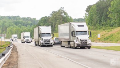 several tractor-trailers on a highway