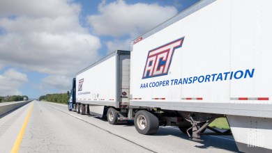 Two AAA Cooper pup trailers being pulled on a highway