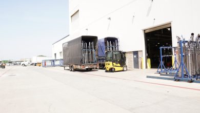 a forklift moving racks outside of a warehouse
