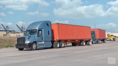 tractors pulling ocean containers leavings a port