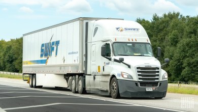 a Swift Transportation tractor-trailer on a highway